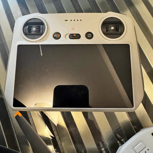 DJI Mini 3 drone remote with built-in screen and control buttons