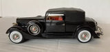 Black diecast classic car model with red interior, 1:27 scale, detailed wheels
