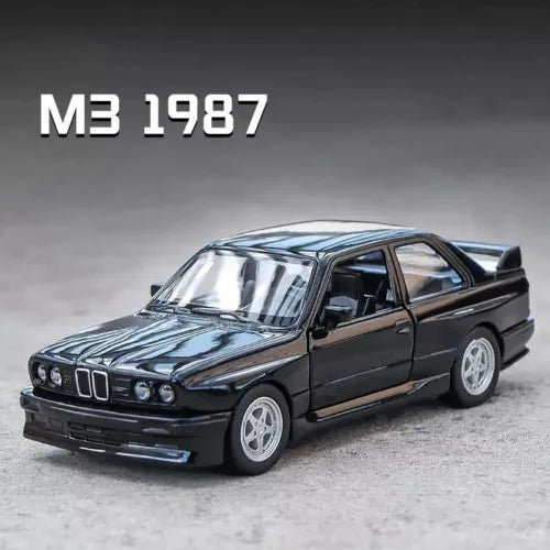 Diecast toy car BMW M3 1987, dark blue coupe with alloy wheels.