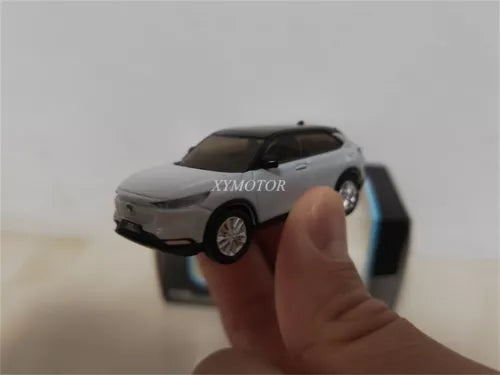 Diecast metal car model, white SUV with black grille, handheld front view