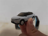 Diecast metal car model, white SUV with black grille, handheld front view