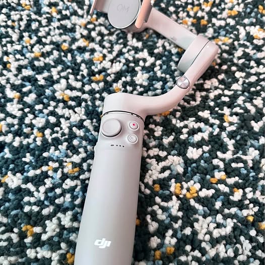 DJI OM5 phone gimbal stabilizer with folding grip and clamp, light gray