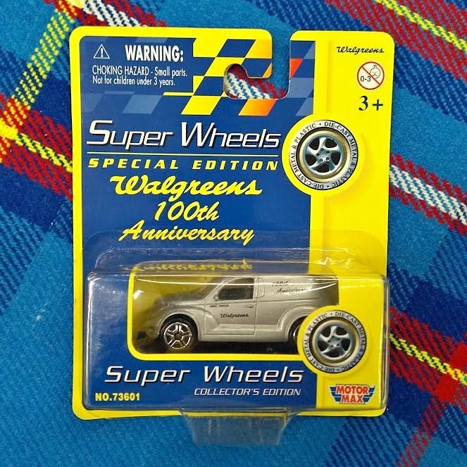 Diecast car in retail blister pack, silver PT Cruiser style with Super Wheels branding