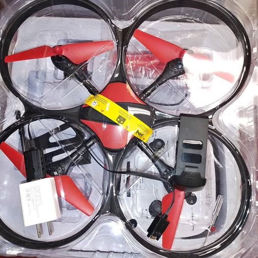 Red Heron camera drone set with four red propellers and black controller parts