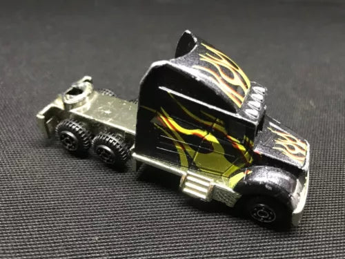 1:64 black diecast truck rig with flame decals, chrome details and trailer hitch