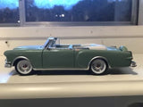 Dark green diecast convertible car, side view, open-top