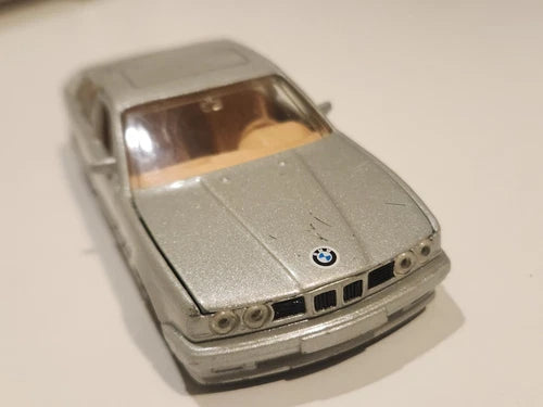Metallic grey diecast toy car, front view with BMW badge and grille, 1/36 scale