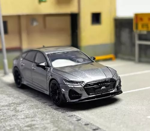 Gray diecast sedan model car with black wheels, front view