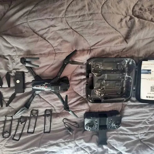 Drone with landing gear, tools, and prop guards in storage case