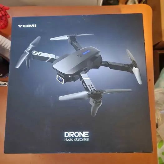 Drone retail box with YOMI branding and illustrated quadcopter, avoid obstacles text