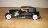Black open-top 1934 diecast car model with whitewall tires, side view