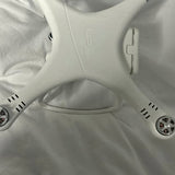 White quadcopter drone with propeller guards and vented motors