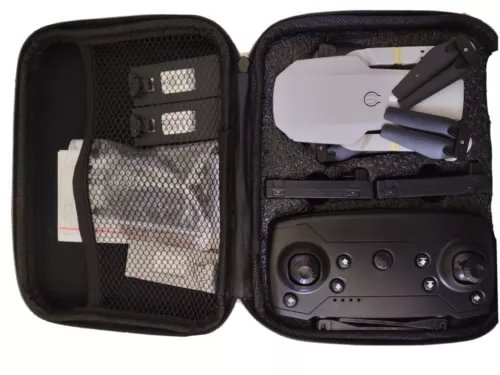 RC drone in open hard case, showing body controls and prop guards