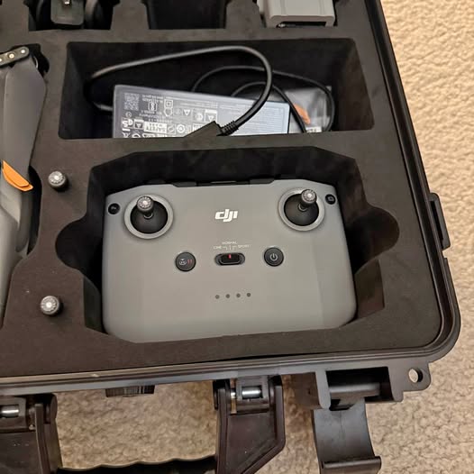 DJI Air 2S drone in open hard case, gray with front sensors and prop hubs