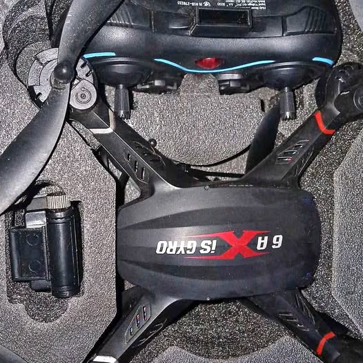 Black quadcopter drone with prop guards and blue LED strips