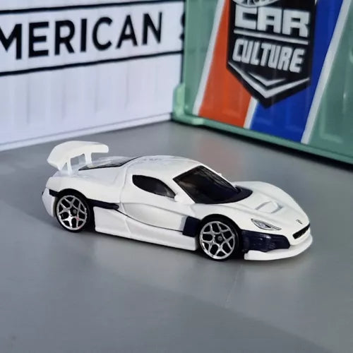 1:64 diecast model car of a white sports coupe with black wheels and tinted windows