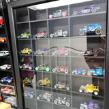 Diecast vehicle display case with assorted miniature cars and trucks on shelves