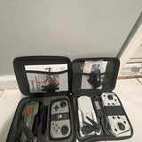 Hard-shell drone case with two quadcopter drones and remote controllers, accessories inside
