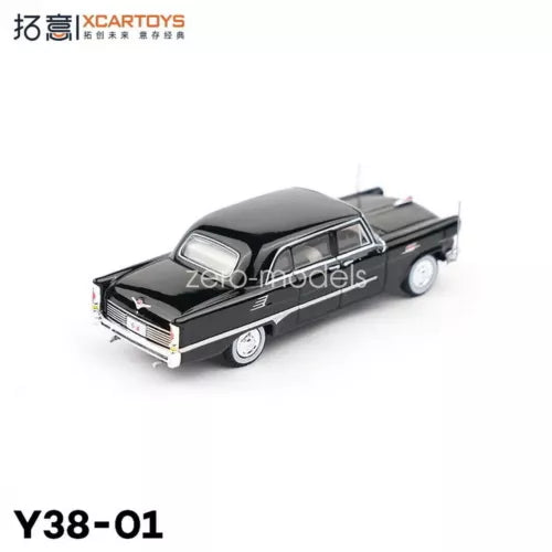 Black 1/64 diecast toy car in front three-quarter view, chrome grille details