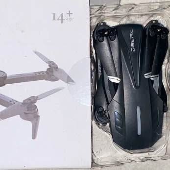 Camera drone with black and gray body, front camera and folded prop arms