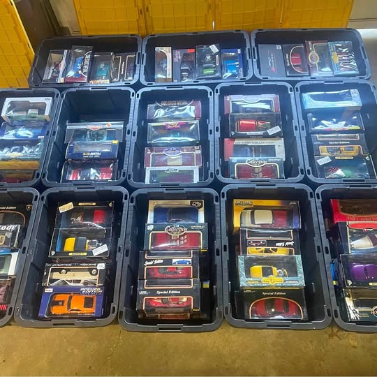 1:18 diecast car display set with multiple boxed cars in compartments