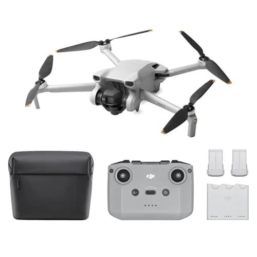 Compact quadcopter drone with camera, remote controller, carrying case, and extra batteries