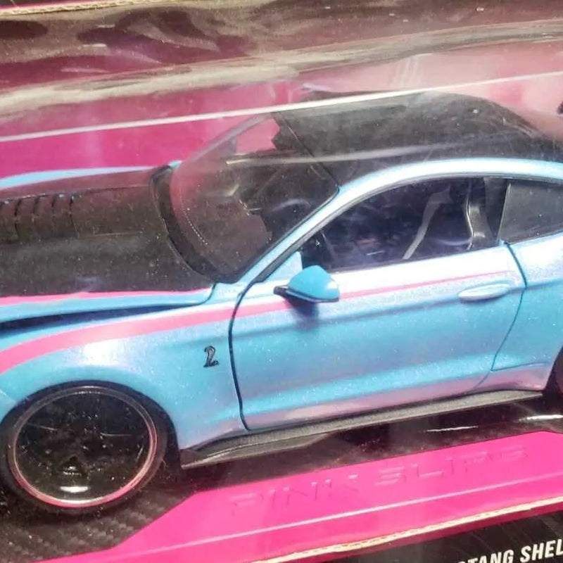 Diecast car, light blue with black wheels and side profile