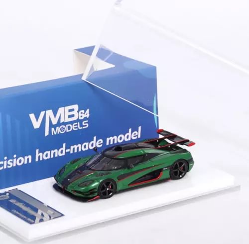 Green racing sports model diecast car with black hood and red rear accents