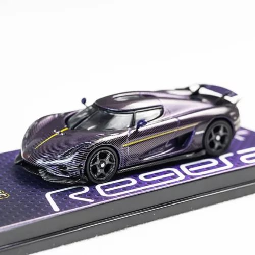 Purple diecast car model with carbon-fiber hood on dark display base