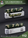 Camouflage intercontinental missile diecast model on display base, dark green and tan.