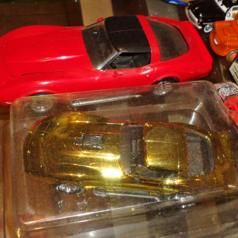 Blister-packaged diecast sports car model, red body with clear windshield