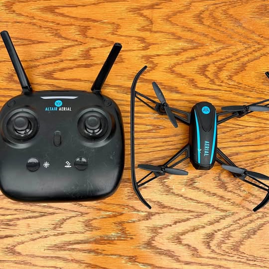 Altair Aerial quadcopter drone with controller, black remote and compact body