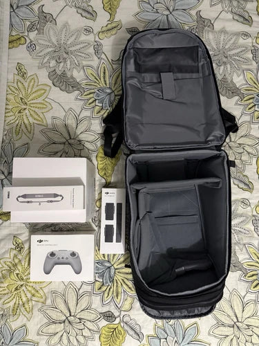Black zippered carry case with interior compartments and accessory items