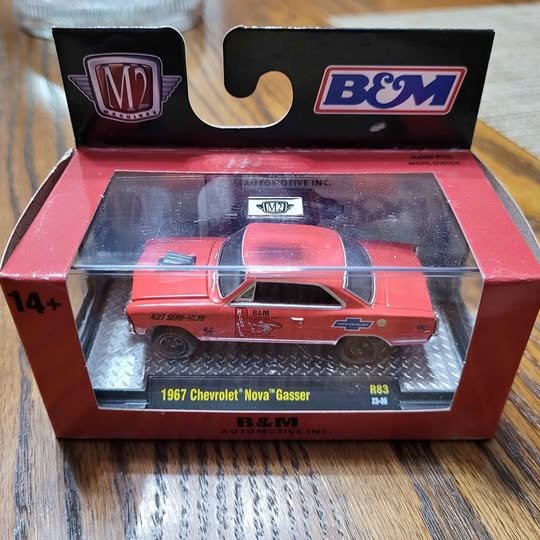 Red 1967 Chevrolet Nova Gasser diecast model in open B&M retail box
