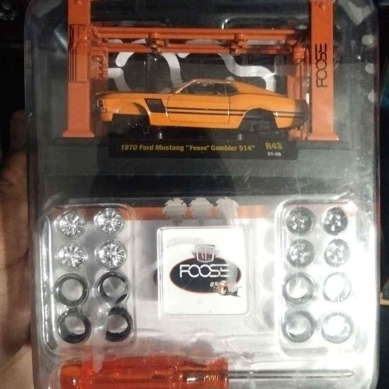 Orange diecast Ford Mustang model in blister pack with wheels and decals, front view