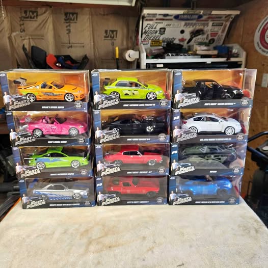 Diecast racing cars set in retail display boxes, multiple colors