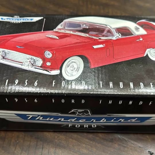 Red vintage Ford Thunderbird diecast car model with chrome grille and whitewall tires