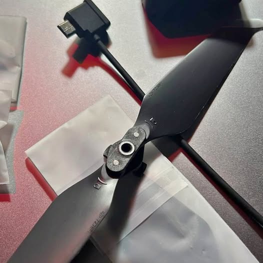 Drone propeller with black blades and mounting hub