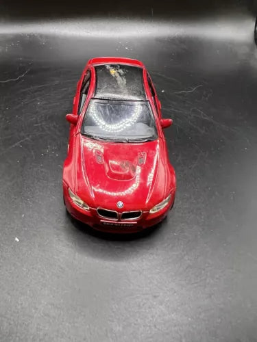 Red 1/36 diecast coupe model car, front view with grille and headlights