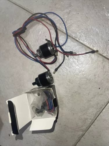 Drone motor set with two black motors, wiring harness, and mounting brackets