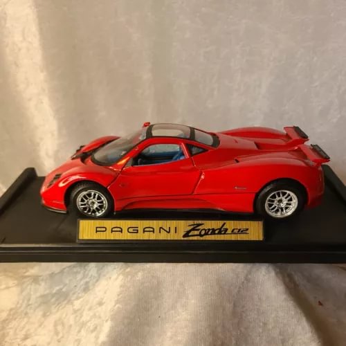 Red Pagani Zonda C12 diecast model car with rear spoiler on display base