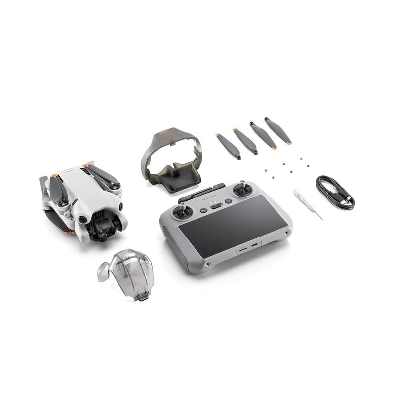 White drone with remote controller screen, extra propellers and cable