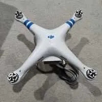 White quadcopter drone with four propellers and central body, top view