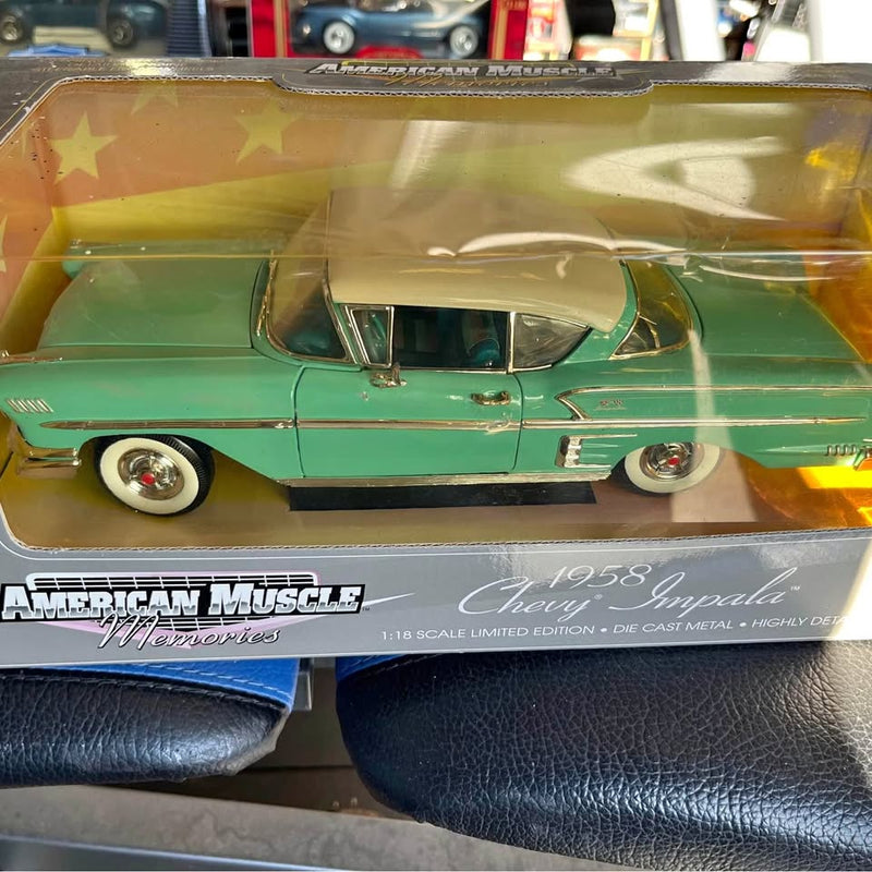Green 1:18 scale diecast car with chrome details and roof fins, boxed model