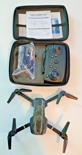 Foldable quadcopter drone with remote controller and accessories in carrying case