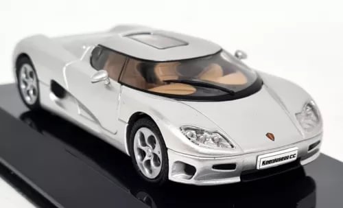 Silver supercar diecast model car with black hood stripe, front 3/4 view