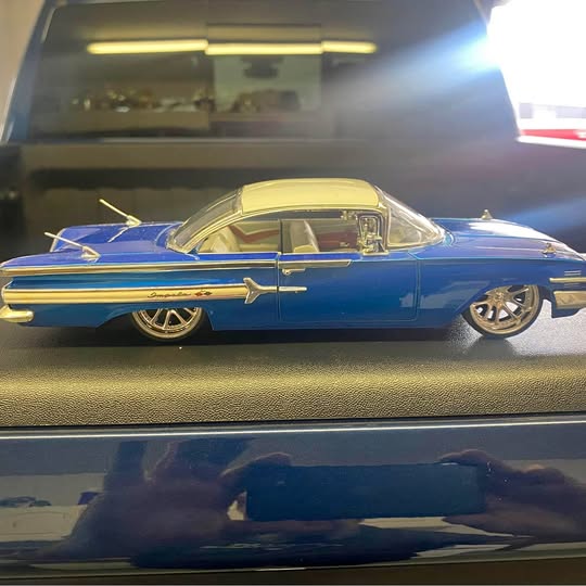 Blue diecast classic car with yellow roof, chrome trim, and detailed wheels