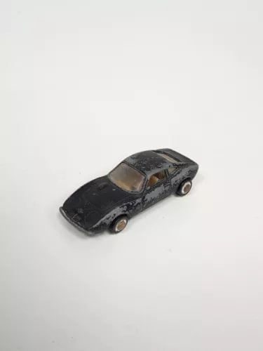 Vintage diecast toy car, black Opel GT-style coupe with detailed headlights