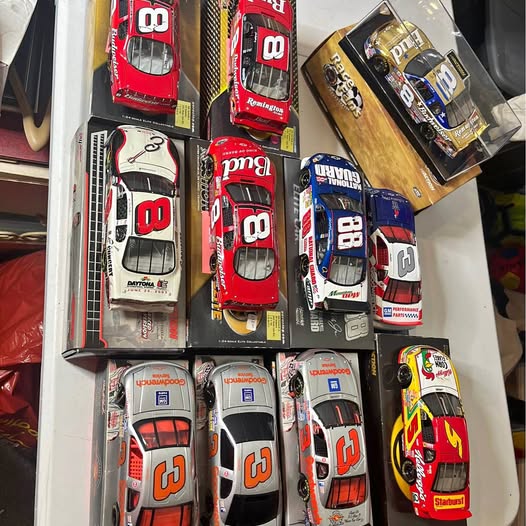 Set of 1/24 Nascar diecast cars in blister packaging, red, white, and blue models