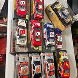 Set of 1/24 Nascar diecast cars in blister packaging, red, white, and blue models